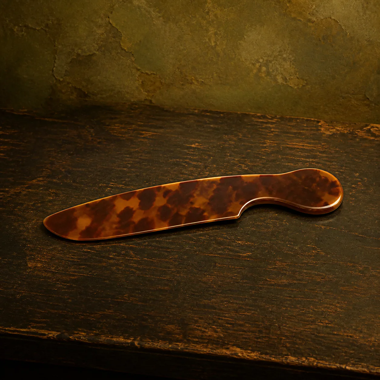 Editorial interpretation of a polished tortoiseshell comb deliberately made with no teeth