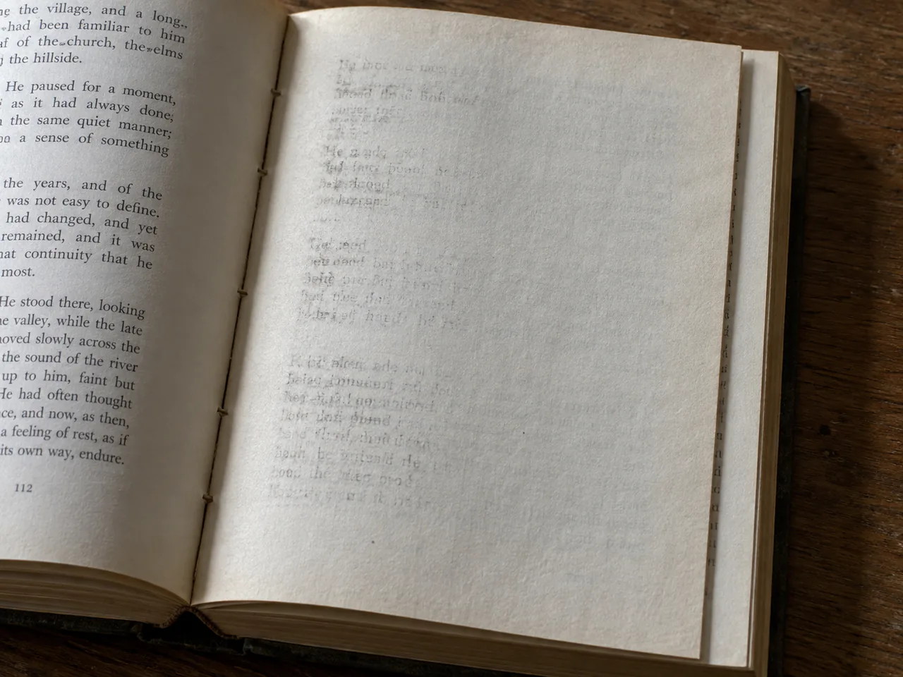 An ordinary thin cream leaf bound into an open book, carrying pale reversed and incomplete ink impressions, with binding thread and paper texture visible in light from the left.